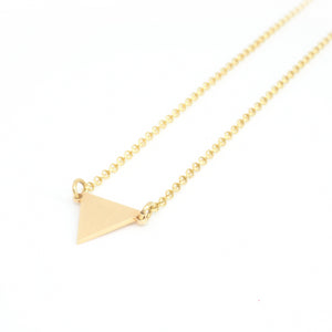 Triangle pendant from the Minimal collection by PLATÓNICA. Gold plated silver. Minimalist jewelry. Contemporary jewelry. Author jewelry. Made in Granada, Andalusia, Spain. Jewelry workshop in the Albaicín. Crafts. Hand-made jewelry. Jewels made from Andalusia. Geometry. Simple and elegant style.